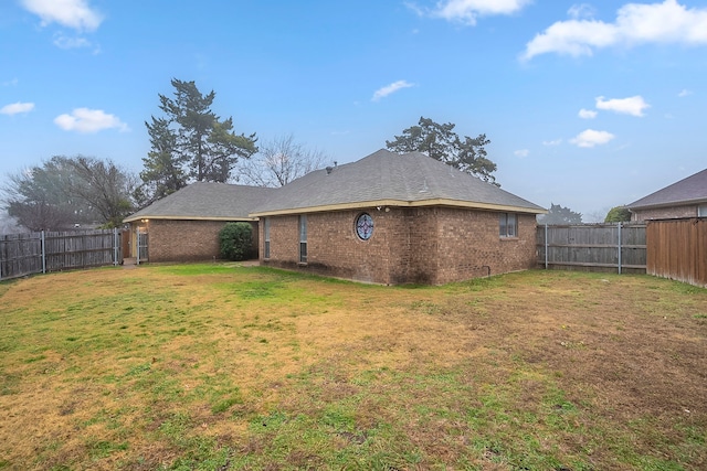 rear view of property with a lawn