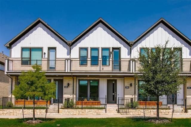 view of front of property with covered porch and a balcony