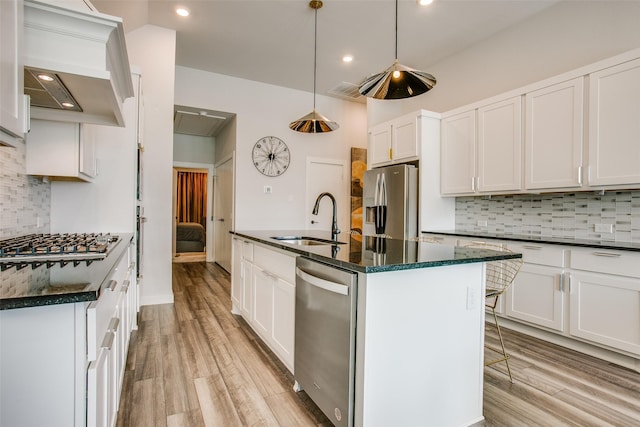 kitchen with sink, white cabinetry, stainless steel appliances, and hanging light fixtures