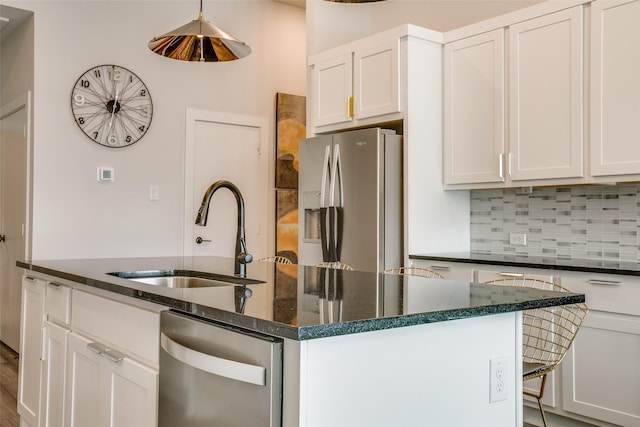 kitchen with appliances with stainless steel finishes, white cabinetry, and sink