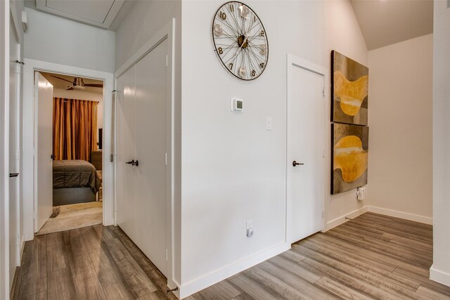 corridor with hardwood / wood-style flooring