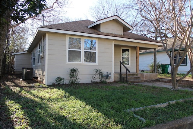 bungalow featuring central AC unit and a front yard