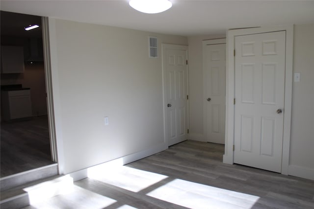 unfurnished bedroom with wood-type flooring