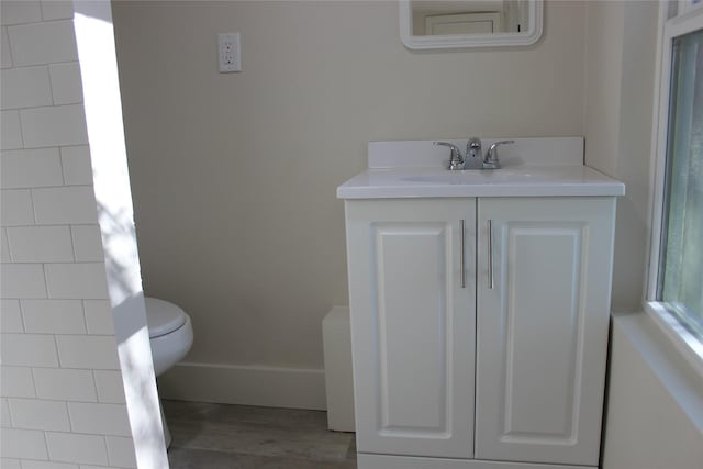 bathroom featuring hardwood / wood-style floors, vanity, and toilet