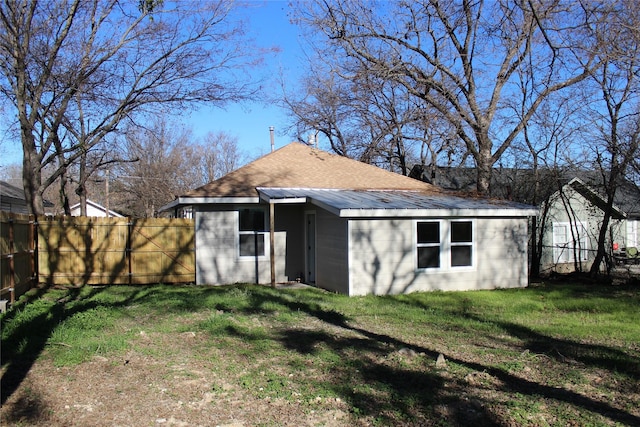 rear view of house with a lawn