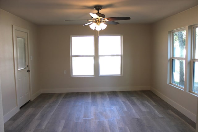 unfurnished room featuring dark wood-type flooring and ceiling fan