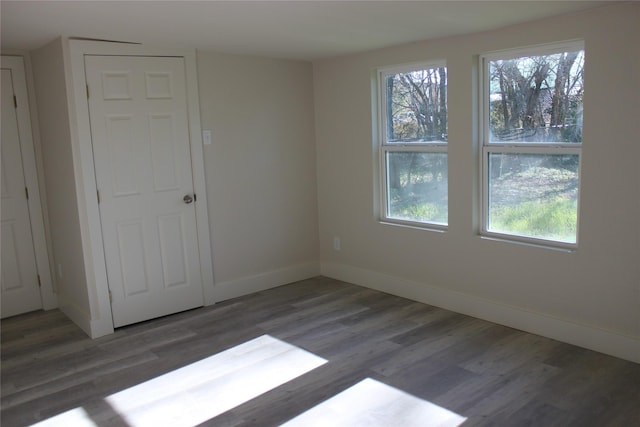 spare room featuring dark wood-type flooring