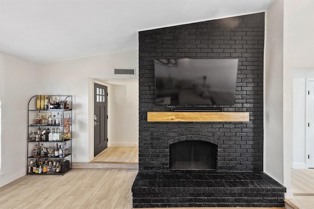 living room featuring a fireplace, hardwood / wood-style flooring, and lofted ceiling