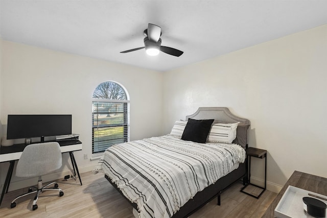 bedroom with ceiling fan and hardwood / wood-style flooring