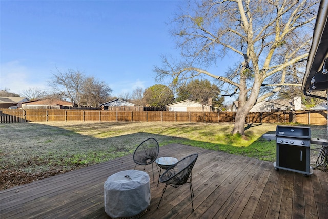 deck featuring a lawn and grilling area