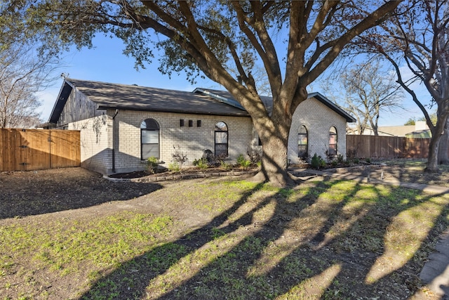 rear view of property featuring a lawn