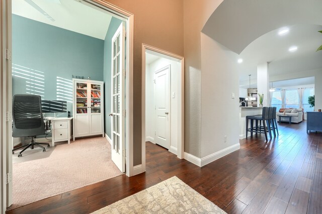 office area with dark hardwood / wood-style floors, lofted ceiling, and french doors