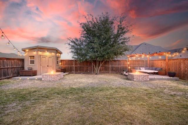 yard at dusk featuring outdoor lounge area and a shed