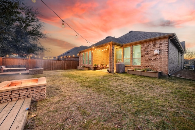 exterior space with a lawn and a fire pit