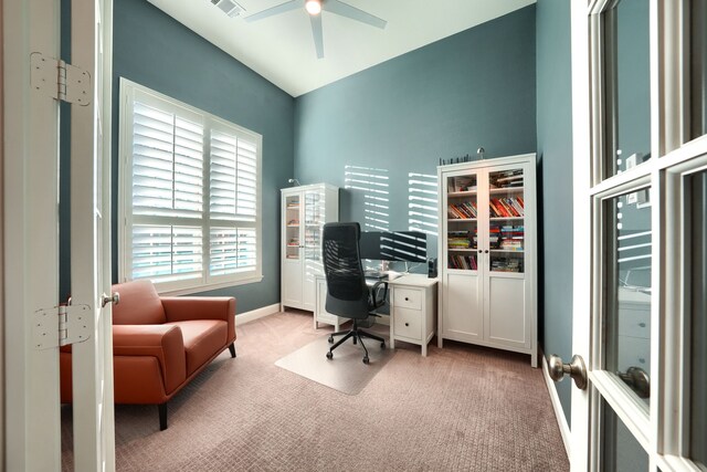 home office with french doors, light colored carpet, and ceiling fan