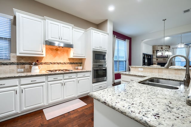 kitchen featuring pendant lighting, stainless steel appliances, white cabinetry, and sink