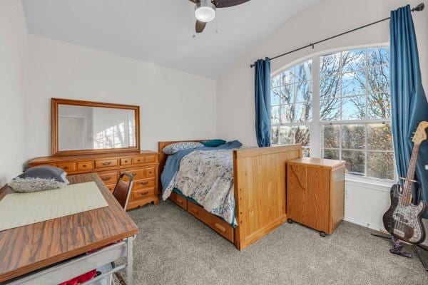 bedroom with light carpet, multiple windows, vaulted ceiling, and ceiling fan