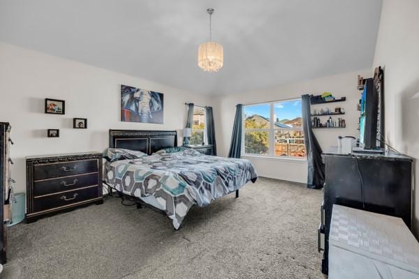 carpeted bedroom with a chandelier