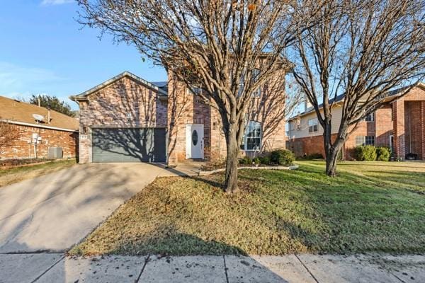 view of front of property featuring a front yard and a garage