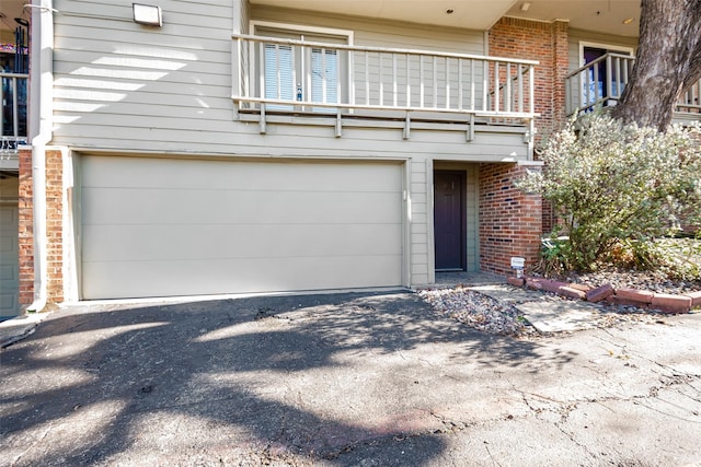 exterior space with a balcony and a garage