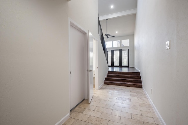 stairway featuring french doors, a towering ceiling, tile patterned floors, and ceiling fan