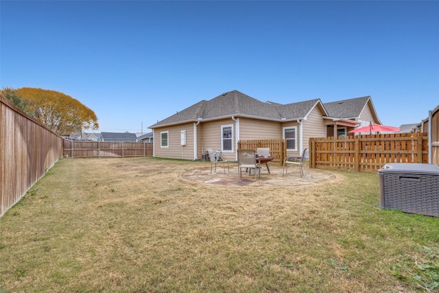 back of property featuring a lawn and a patio area