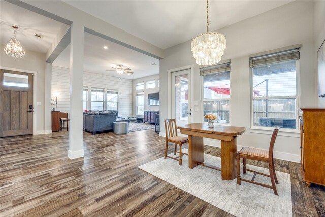 dining room featuring wood-type flooring and ceiling fan with notable chandelier