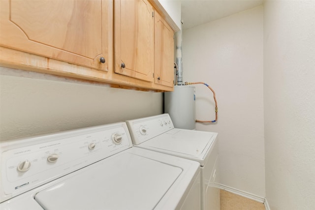 washroom with cabinets, gas water heater, and separate washer and dryer