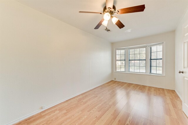 empty room featuring ceiling fan and light hardwood / wood-style floors