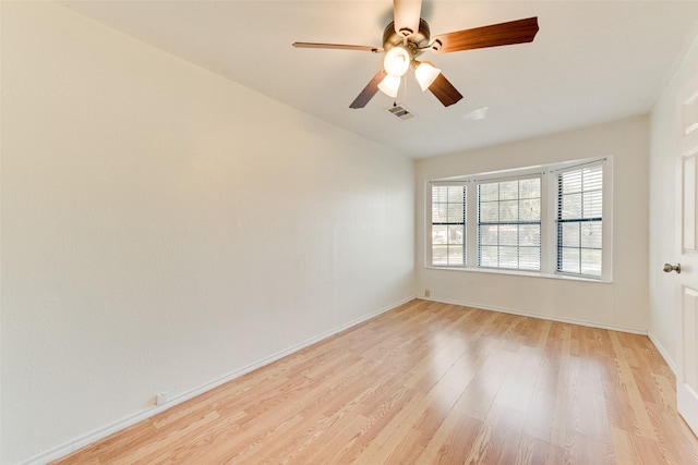 empty room featuring ceiling fan and light hardwood / wood-style floors