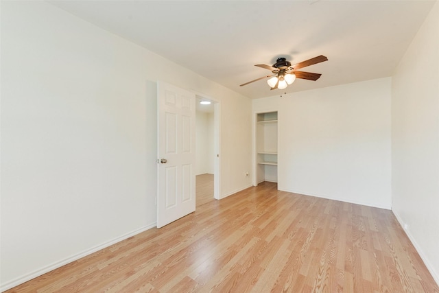 unfurnished bedroom with light wood-type flooring, a closet, and ceiling fan