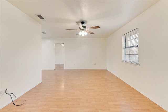 empty room featuring ceiling fan and light hardwood / wood-style flooring