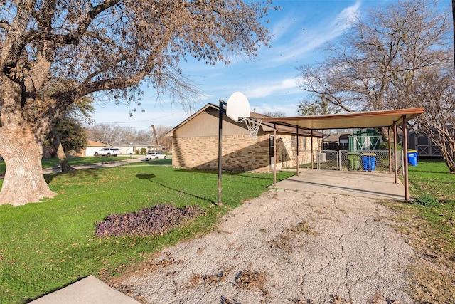 view of home's exterior featuring a carport and a lawn