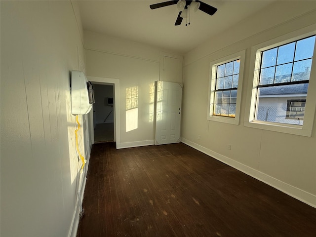 spare room with ceiling fan and dark hardwood / wood-style flooring