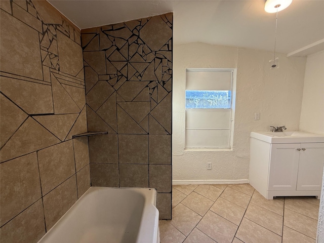 bathroom with sink, tile patterned flooring, and a bathtub