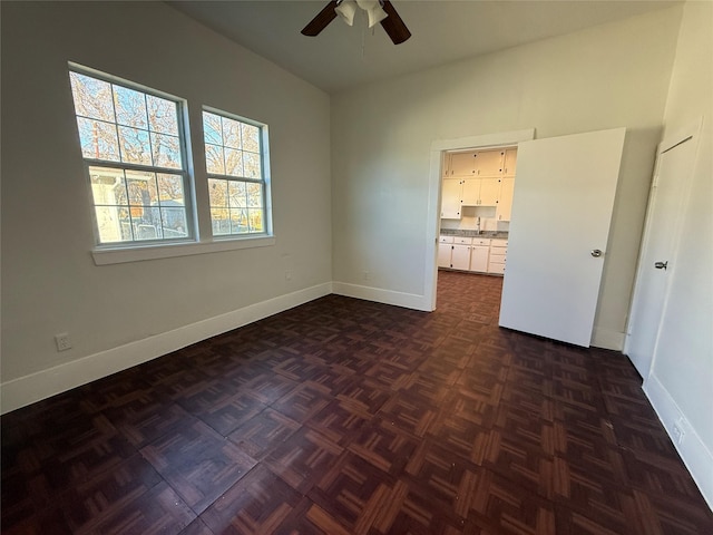 unfurnished bedroom featuring dark parquet floors and ceiling fan