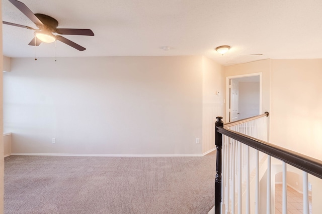 spare room with carpet flooring and ceiling fan