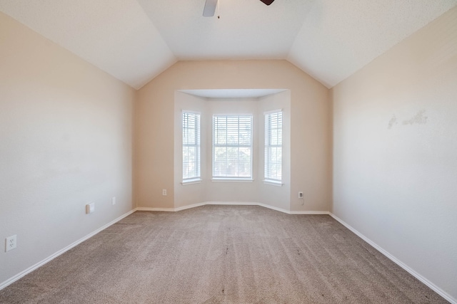 spare room with carpet floors, ceiling fan, and lofted ceiling