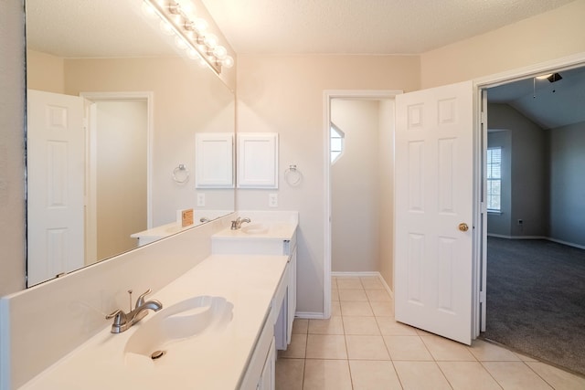 bathroom featuring tile patterned floors, vanity, and a textured ceiling