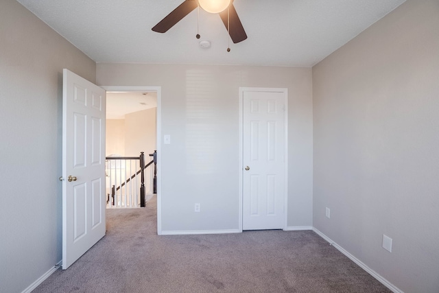 unfurnished bedroom featuring ceiling fan and light colored carpet