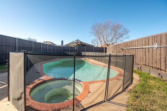 view of pool with an in ground hot tub