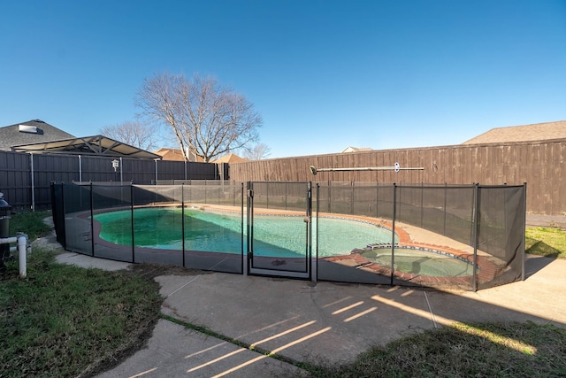 view of pool with an in ground hot tub