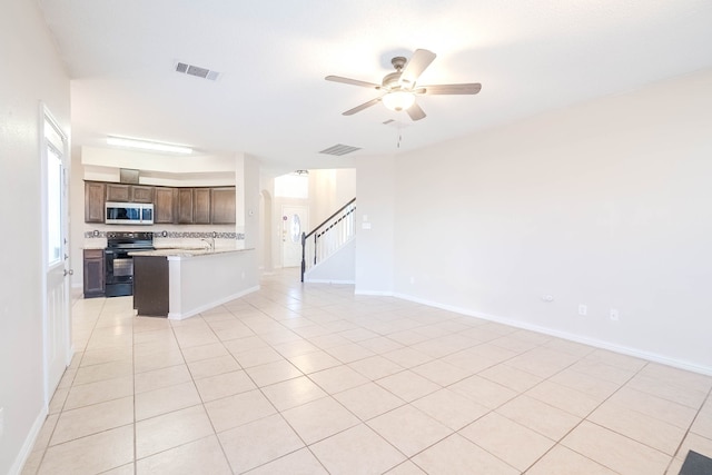 kitchen featuring light tile patterned floors, tasteful backsplash, black electric range oven, and ceiling fan