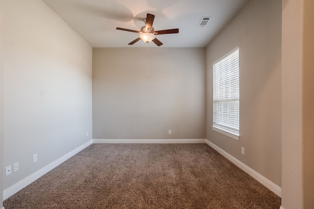 carpeted spare room with ceiling fan