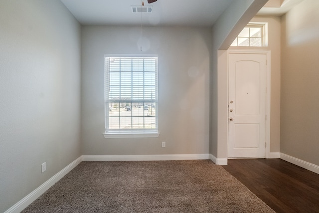 entryway featuring dark carpet