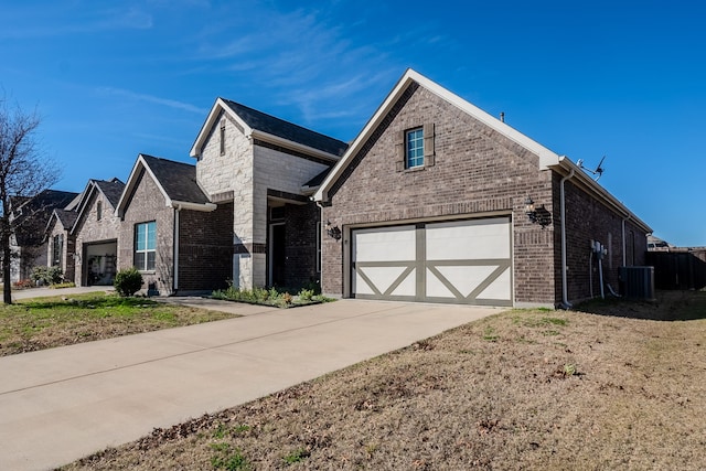 front of property featuring central AC unit and a garage