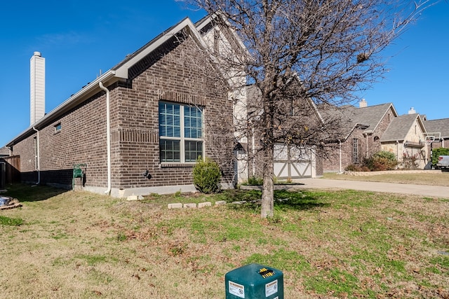 view of front of home featuring a garage and a front lawn