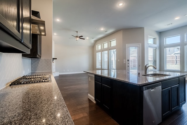 kitchen featuring a kitchen island with sink, sink, dark hardwood / wood-style floors, appliances with stainless steel finishes, and stone countertops