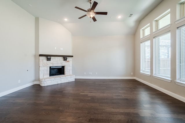 unfurnished living room featuring ceiling fan, a fireplace, dark hardwood / wood-style floors, and lofted ceiling