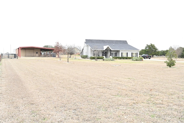 view of front of property with an outdoor structure and a carport